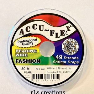 May include: A spool of 30 feet (9.1 meters) of Accu-Flex beading wire. The wire is color-coated stainless steel, has 49 strands, and is described as "Softest Drape". The spool is labeled "Professional Quality" and "Fashion Pearl".