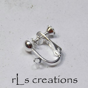 May include: Silver tone ear clip with a screw-on back and a loop for attaching a dangle charm.