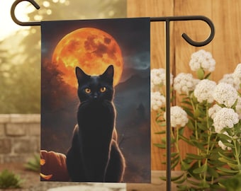 May include: A black cat sits in front of a large orange moon with a dark, spooky background. The cat has bright yellow eyes and is looking directly at the viewer. This is a Halloween-themed garden flag.