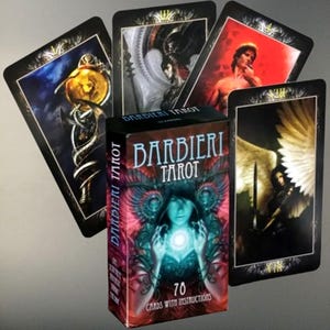 May include: A Barbieri Tarot deck with 70 cards and instructions. The box features a woman with glowing blue energy. Four tarot cards are fanned out, each with unique illustrations in shades of blue, red, and gold. The deck is designed for divination.