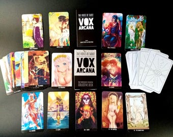 May include: A Vox Arcana tarot deck featuring a black box with white text and numerous illustrated cards with colorful anime-style artwork. The cards display various figures, symbols, and scenes, with some cards showing white backs featuring a central eye design.