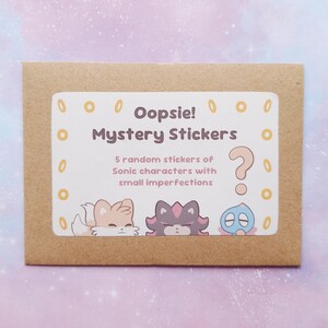 May include: A brown paper envelope with a white label that reads "Oopsie! Mystery Stickers." The label features illustrations of Sonic characters and a question mark. The text indicates the package contains 5 random stickers with small imperfections.