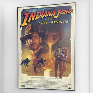 May include: Indiana Jones and the Fate of Atlantis movie poster. The poster features a portrait of Indiana Jones wearing a fedora, with the title in large, yellow letters. Other characters and imagery from the film are also depicted.