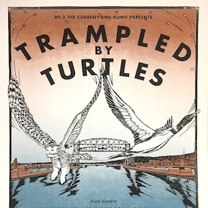 May include: A concert poster for Trampled by Turtles, with a red, orange, and white background. The poster features a black and white illustration of two owls flying over a bridge. The text "Trampled by Turtles" is in large, bold letters. The poster also includes the text "89.3 The Current and KUMD Presents", "Plus Guests", and "Saturday, July 6th, Bayfront Festival Park - Duluth, MN".