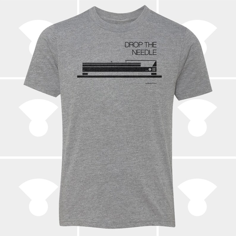 May include: A heather gray t-shirt with a black graphic of a stereo component and the text "DROP THE NEEDLE" above it. The shirt has short sleeves and a crew neck.