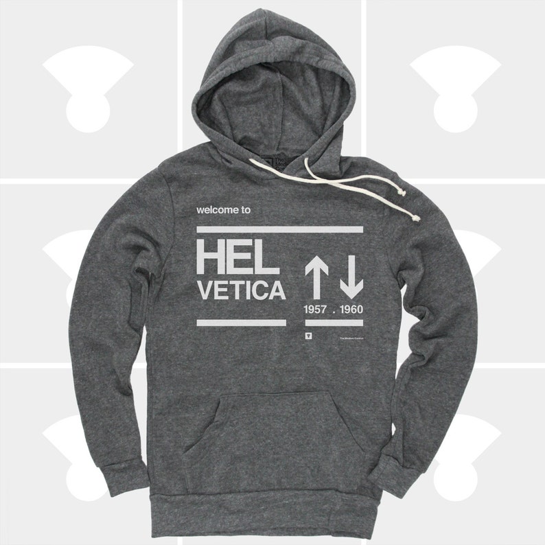K&ouml;nnte beinhalten: Ein dunkelgrauer Kapuzenpullover mit dem Aufdruck "welcome to HELVETICA 1957 - 1960" auf der Vorderseite.