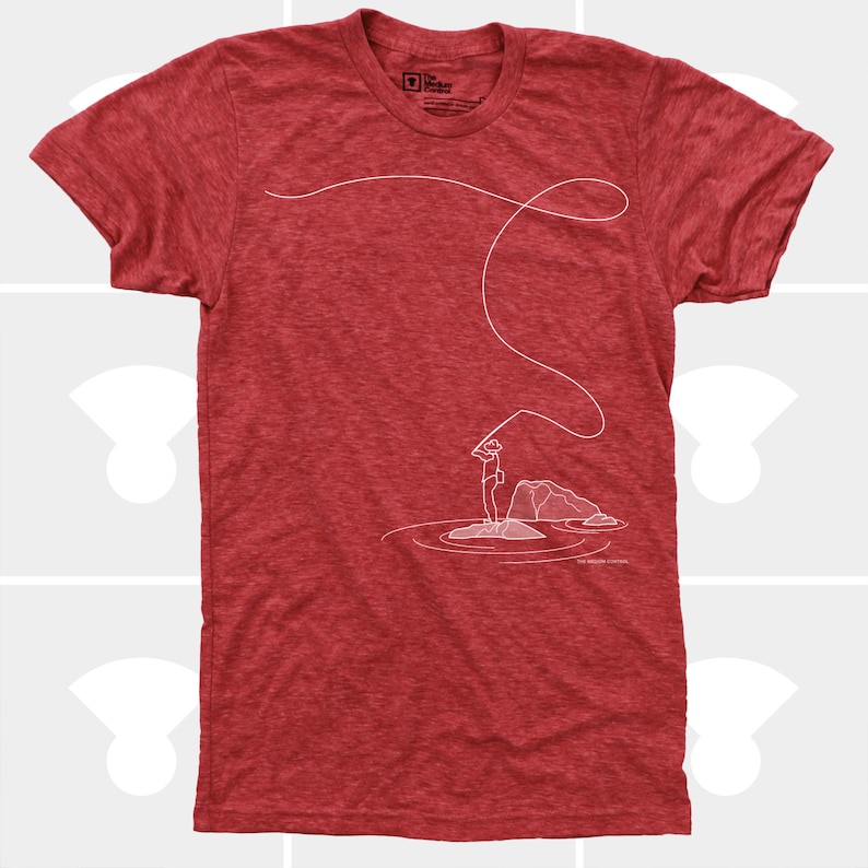 May include: Red heather t-shirt with a white line drawing of a person fly fishing. The design includes a fishing rod, line, and a person standing on a rock in the water. The text "The Modern Control" is at the bottom.