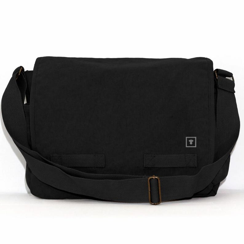 A front-facing studio shot of a black custom-printed messenger bag against a white background. This clear view shows the expansive flap area made from studio-grade canvas, ideal for custom studio designations and logos.