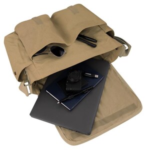 May include: A tan canvas messenger bag, open to reveal contents. Inside are a laptop, notebooks, a camera, a USB drive, pens, and sunglasses. The bag has multiple compartments and a flap closure.