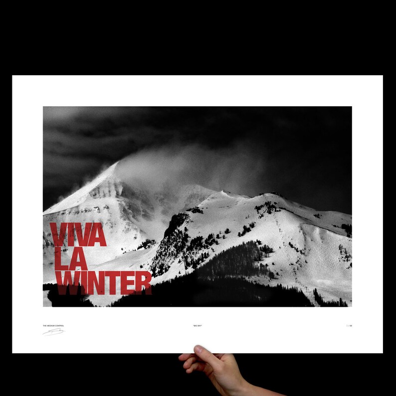 May include: Black and white photograph of a snow-covered mountain range under a dark, cloudy sky. Bold red text reads "VIVA LA WINTER" across the lower left. The image is printed on white paper.