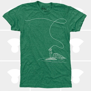 May include: Green t-shirt with a white line drawing of a person fly fishing. The graphic shows a person standing on a rock in water, casting a line. The shirt has a crew neck and short sleeves. The brand logo is in the upper left.