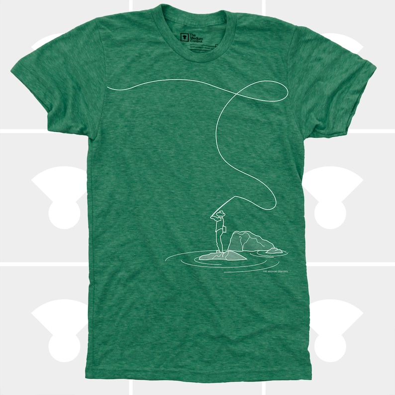May include: Green t-shirt with a white line drawing of a person fly fishing. The graphic shows a person standing on a rock in water, casting a line. The shirt has a crew neck and short sleeves. The brand logo is in the upper left.
