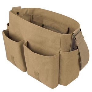 May include: A tan canvas messenger bag with multiple exterior pockets and a long adjustable shoulder strap. The bag has a large main compartment with a zippered pocket inside. The bag is made of durable canvas material.