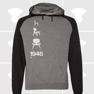 May include: A gray and black hooded sweatshirt with a white silhouette of four chairs and the year 1946 printed on the front.