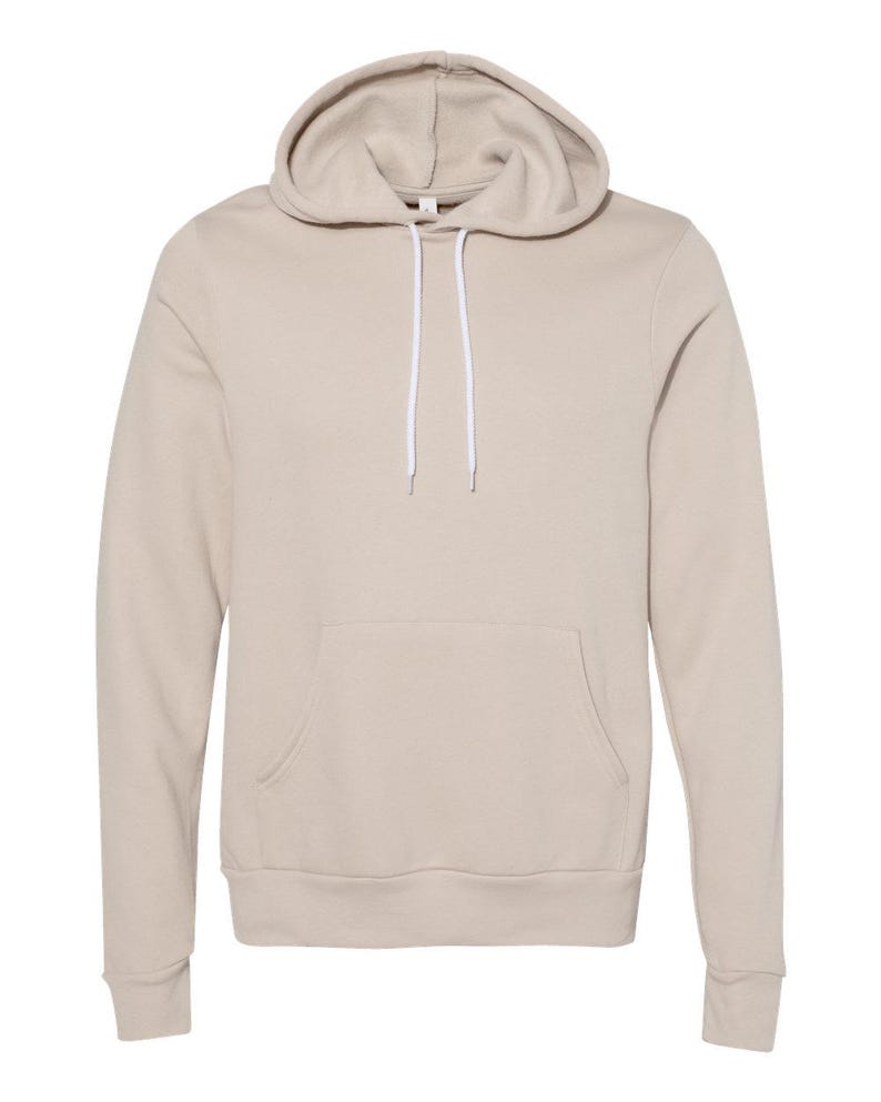 May include: A beige hooded sweatshirt with a front pouch pocket and white drawstrings.