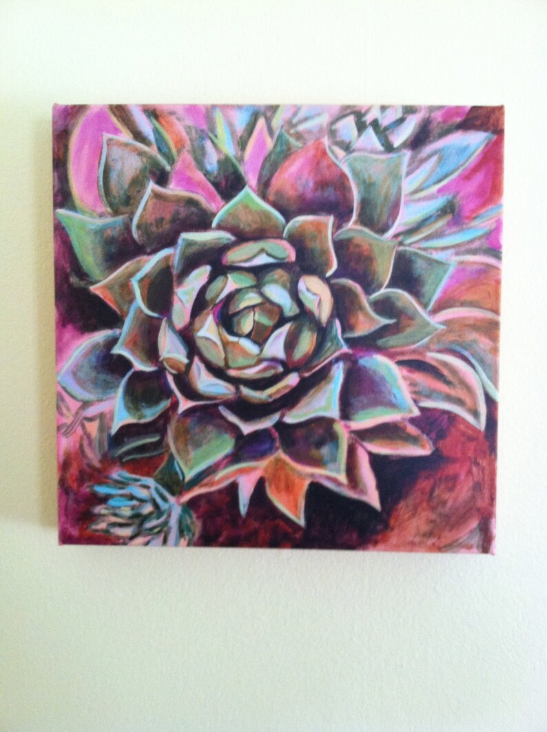 May include: A close-up of a painting of a succulent plant with green, purple, and orange petals. The background is a dark pink and red.