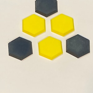 May include: A set of six hexagonal tiles, three are yellow and three are black.