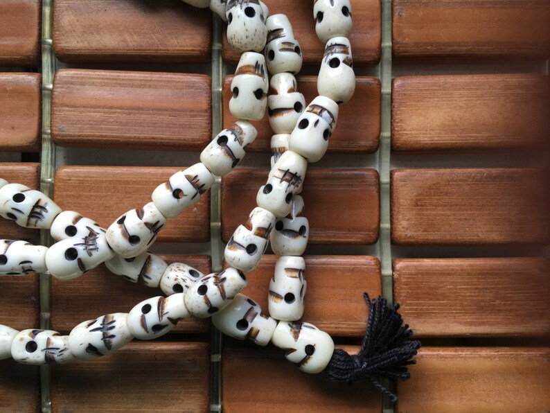 108 carved 8x14mm white bone skull bead mala