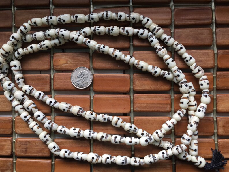 108 carved 8x14mm white bone skull bead mala