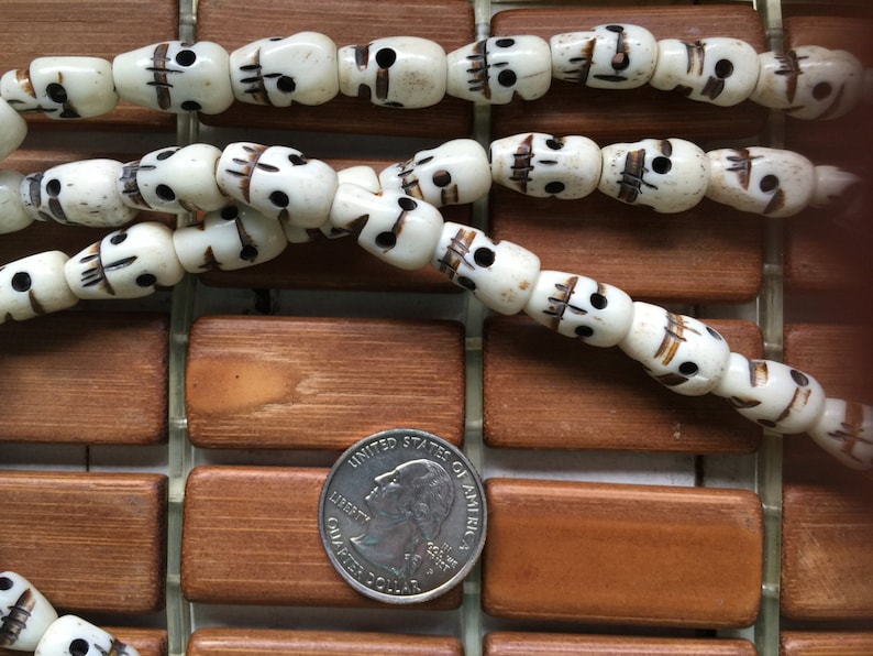 108 carved 8x14mm white bone skull bead mala