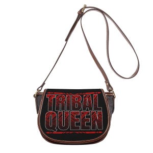 May include: A black saddle bag with the words "TRIBAL QUEEN" in red and white. The bag has a brown leather strap and trim. The design features tribal patterns.