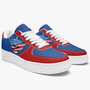 May include: Red, white, and blue sneakers with a skull and wings design. The sneakers have a white sole and a blue and red upper.