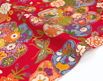 May include: Red Japanese fabric with a repeating pattern of colorful flowers, butterflies, and fan-shaped designs. The fabric features orange, purple, green, and white floral elements. The text "MIATA TABI JAPANESE FABRIC" is visible.