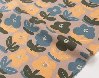 May include: A light mauve fabric featuring a repeating pattern of stylized flowers in muted blue, mustard yellow, and dark olive green. Each flower has a simple five-petal shape with white center details. The fabric has a visible woven texture.