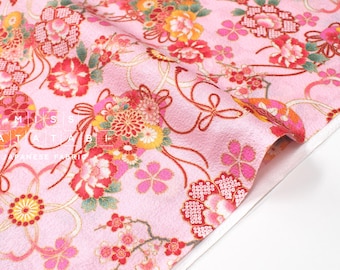 May include: Pink fabric with a floral pattern featuring red, yellow, and white flowers. The fabric has a delicate, almost shimmering texture.