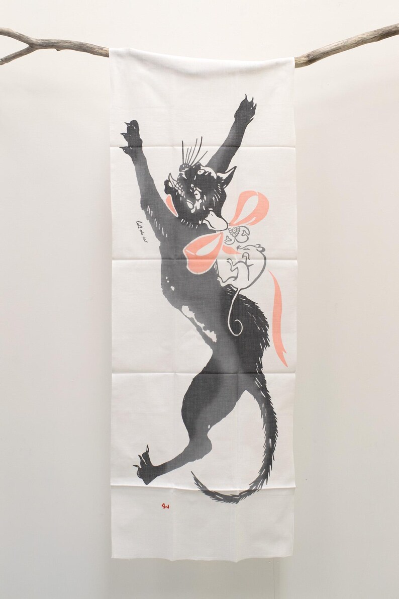 May include: A black cat with a pink bow and a white mouse printed on a white fabric panel. The cat is jumping up with its paws in the air. The text "the new cat" is printed on the panel.