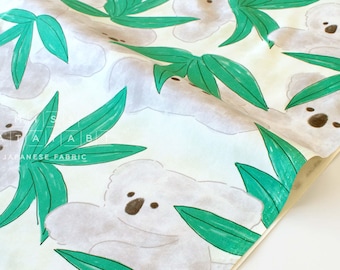 May include: White fabric with a repeating pattern of green leaves and gray koala bears. The fabric has the text "Japanese Fabric" printed on it.