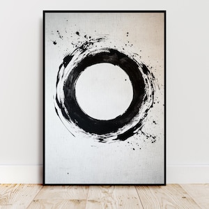 May include: Framed abstract art print. A large, textured black circle dominates the white background. The artwork uses brushstrokes and ink splatters, creating a minimalist and modern aesthetic. The frame is black.