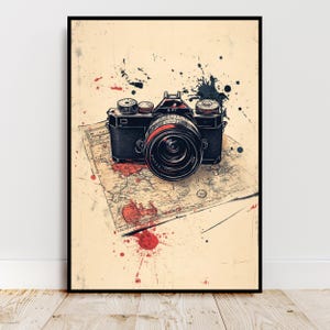 May include: A vintage camera with a lens and red and black accents is on a map with red and black paint splatters. The camera is on a beige background.