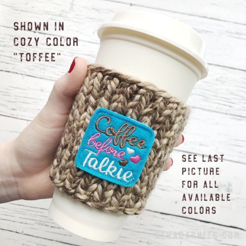 May include: A knitted coffee cup sleeve in a cozy toffee color, with a blue square patch embroidered with "Coffee before Talkie" and hearts. The sleeve is wrapped around a white paper coffee cup. Additional text indicates other colors are available.