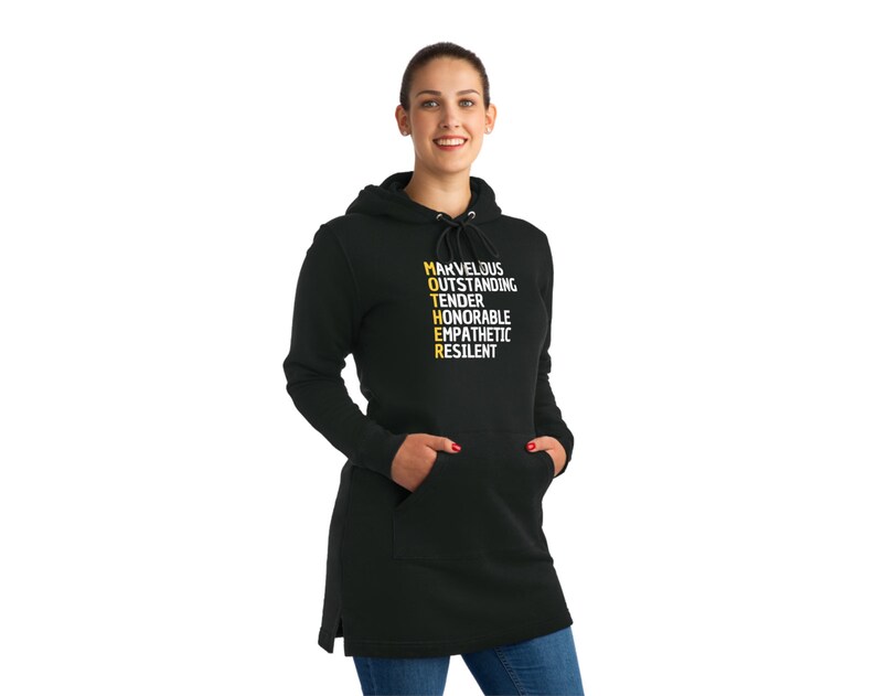 May include: Black hooded sweatshirt with a long length. The front of the sweatshirt has the word "MOTHER" spelled vertically in yellow with the letters "M", "O", "T", "H", "E", and "R" each representing a word: "Marvelous", "Outstanding", "Tender", "Honorable", "Empathetic", and "Resilient".