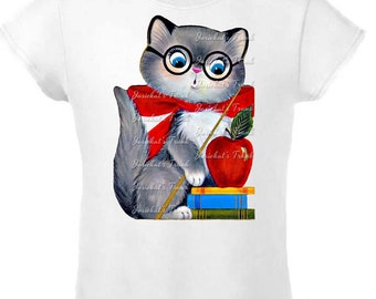 May include: A white t-shirt with a gray cat wearing glasses and a red scarf holding an apple and a pointer. The cat is standing on a stack of books. The text "Josiekat's Trunk" is repeated on the shirt.