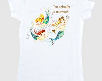 May include: White t-shirt with a graphic of three mermaids with the text "I'm actually a mermaid" printed on the front.