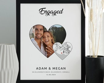 May include: A black framed print with a white background. The print features a couple's photo in a heart shape, with a map of Millendreath Beach, Cornwall, England, in a second heart shape. The text "Engaged" is at the top of the print, and the couple's names, "Adam & Megan", are below the hearts. The date "12.06.2024" is at the bottom of the print.