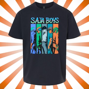 May include: Black t-shirt featuring the text "SAJA BOYS" in a colorful, gradient font. Below the text is a graphic of five anime-style figures in vertical color blocks of blue, green, and orange.