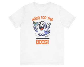 May include: White t-shirt with a cartoon ghost holding a martini glass and the text "Here for the boos!"