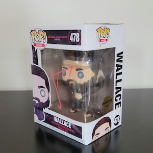May include: A Funko Pop! vinyl figure of Wallace from the movie Blade Runner 2049. The figure is in a display box with the Pop! logo and the number 478. The box has images of the character and the movie title.