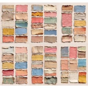 May include: A collection of rectangular, torn paper pieces in various colors, including pink, blue, yellow, and brown. Some pieces have text or lines, while others are solid. The edges are rough, giving a handmade appearance.