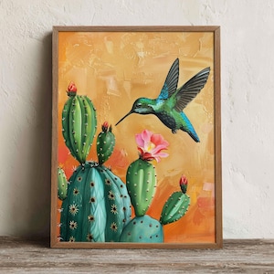 May include: A framed wall art print featuring a vibrant green hummingbird in flight towards a blooming pink flower on a green cactus. The background is a textured, warm orange and yellow gradient, all encased in a simple wooden frame.