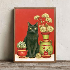May include: A framed wall art print featuring a black cat with yellow eyes sitting between a small red pot containing a green succulent and a tall green vase filled with white flowers, all set against a solid, vibrant red background.