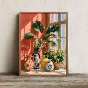 May include: A framed art print depicting a sunlit interior scene with a tall palm plant and several decorative ceramic vases in orange, blue, white, and yellow. The composition includes a window with light streaming onto a coral-colored wall.