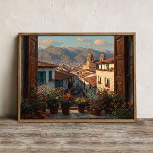 May include: A framed print showing a cityscape viewed through an open window. The artwork depicts a street scene with buildings, mountains, and a blue sky. Colourful flowers in terracotta pots line the window ledge.