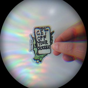 May include: A holographic sticker with a cartoon hand holding a smartphone. The phone screen says "GET OFF YOUR SCREEN".