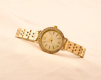 women wrist watch,gold colour,case with stone ,adjustable band