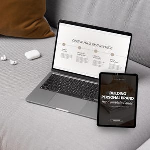 May include: A laptop computer with a presentation on a screen titled "Define Your Brand Voice" and a digital guide titled "Building Personal Brand the Complete Guide" on a tablet.