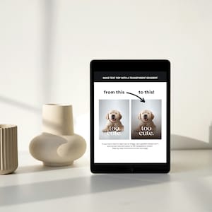 May include: A black tablet displays a tutorial on making text pop with a transparent gradient. The tutorial shows two images of a golden retriever puppy with the text "too cute." Beside the tablet are two beige ceramic vases.